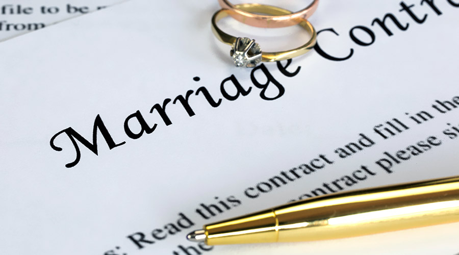 close up of marriage contract with a pair of rings and a golden pen on top jacksonville fl